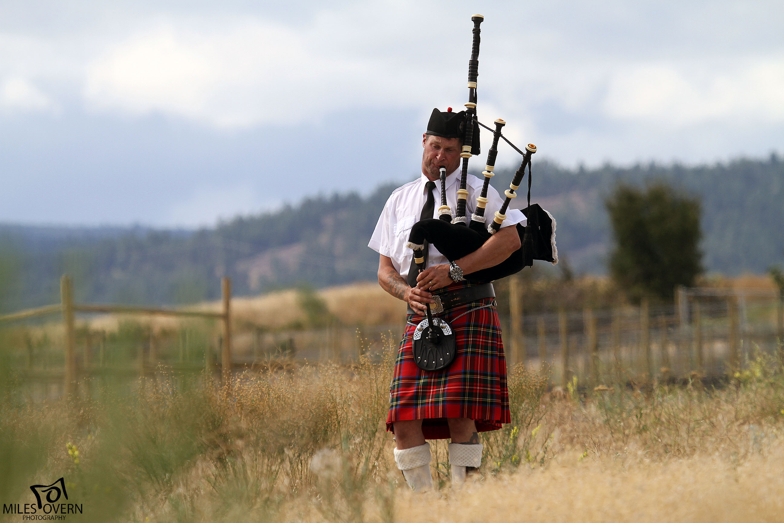 Wedding Photo of Bagpiper in Meadow at Sanctuary Gardens